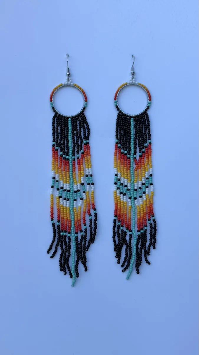 Pair of beaded hoop earrings with black, teal and orange fringe.