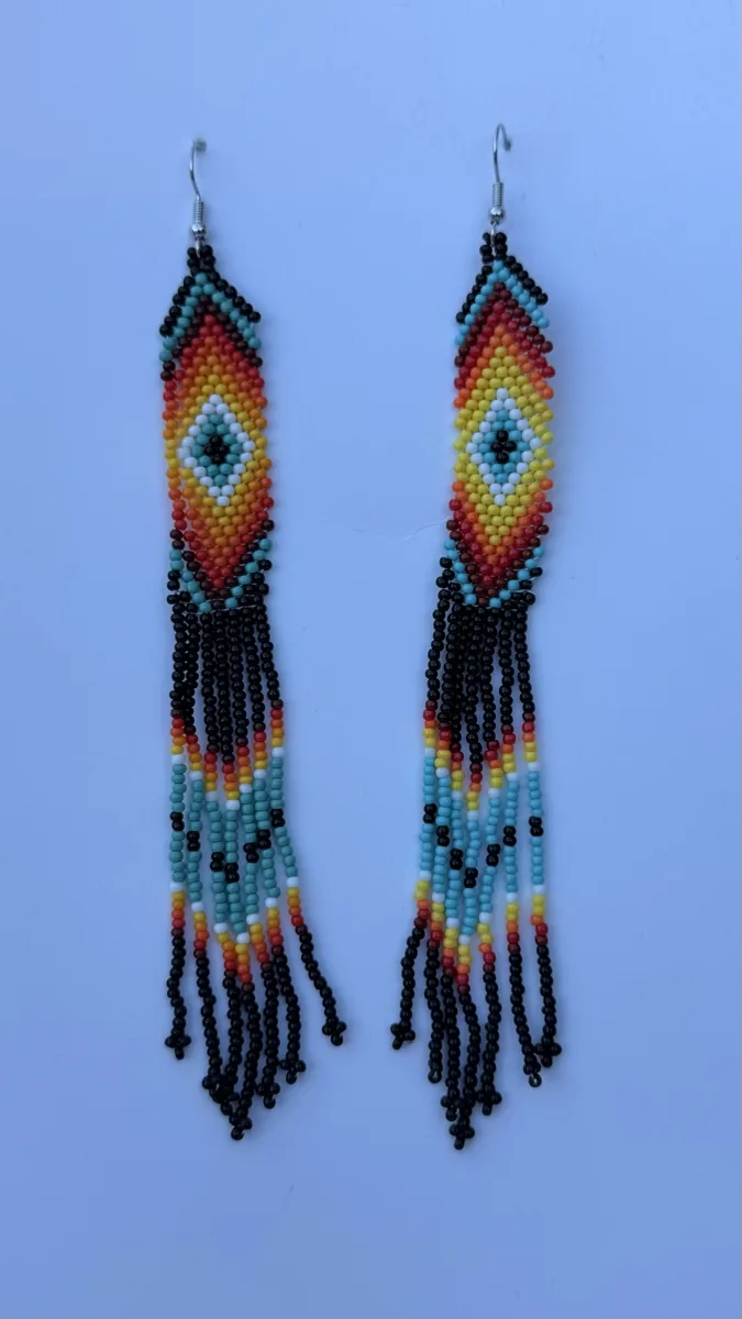 Pair of turquoise and black beaded drop earrings with colorful fringe.