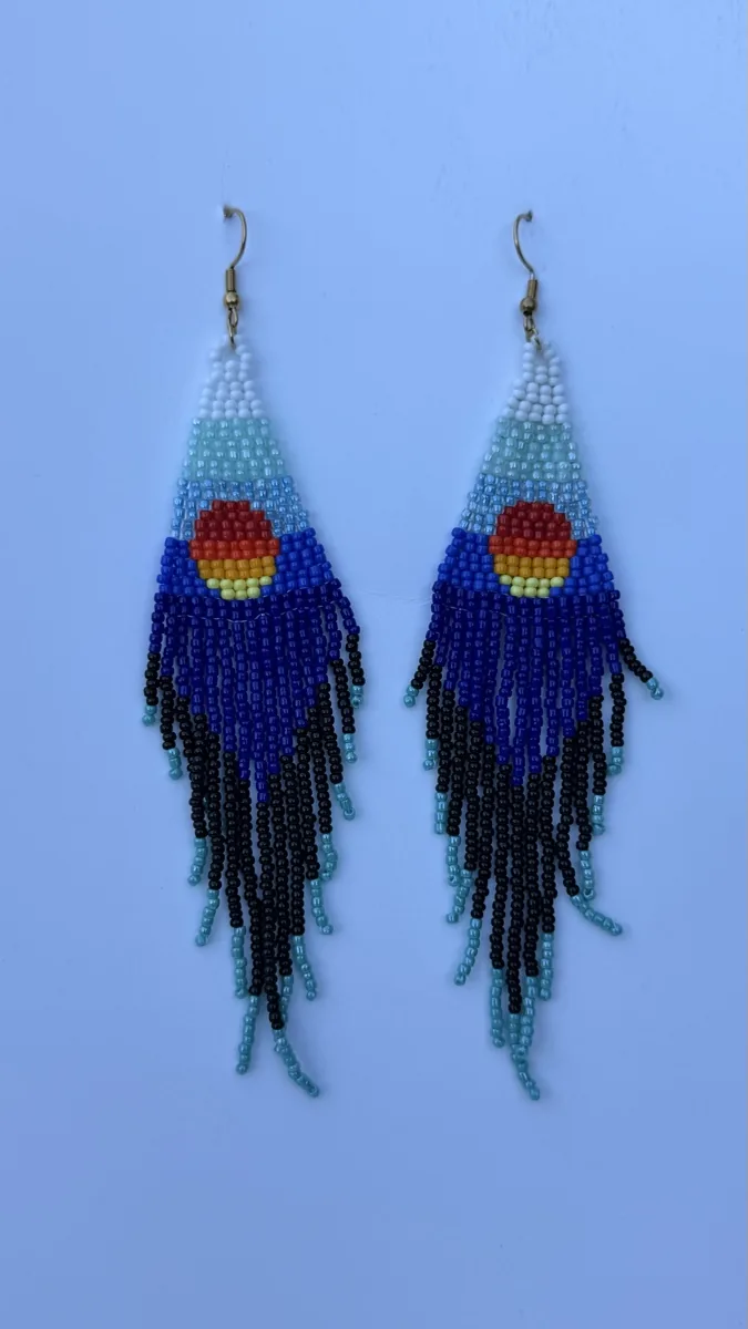 Pair of beaded earrings with blue gradient triangles and orange sun, black fringed drops.