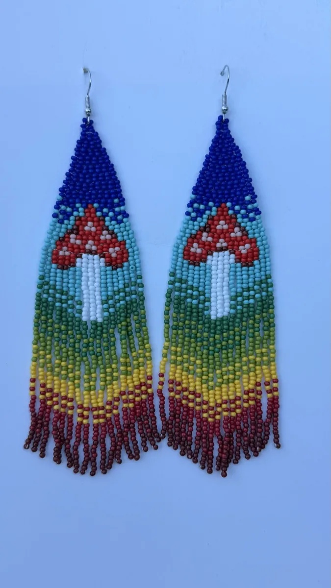 Pair of beaded drop earrings with navy tops, rainbow gradients, and red mushroom designs.