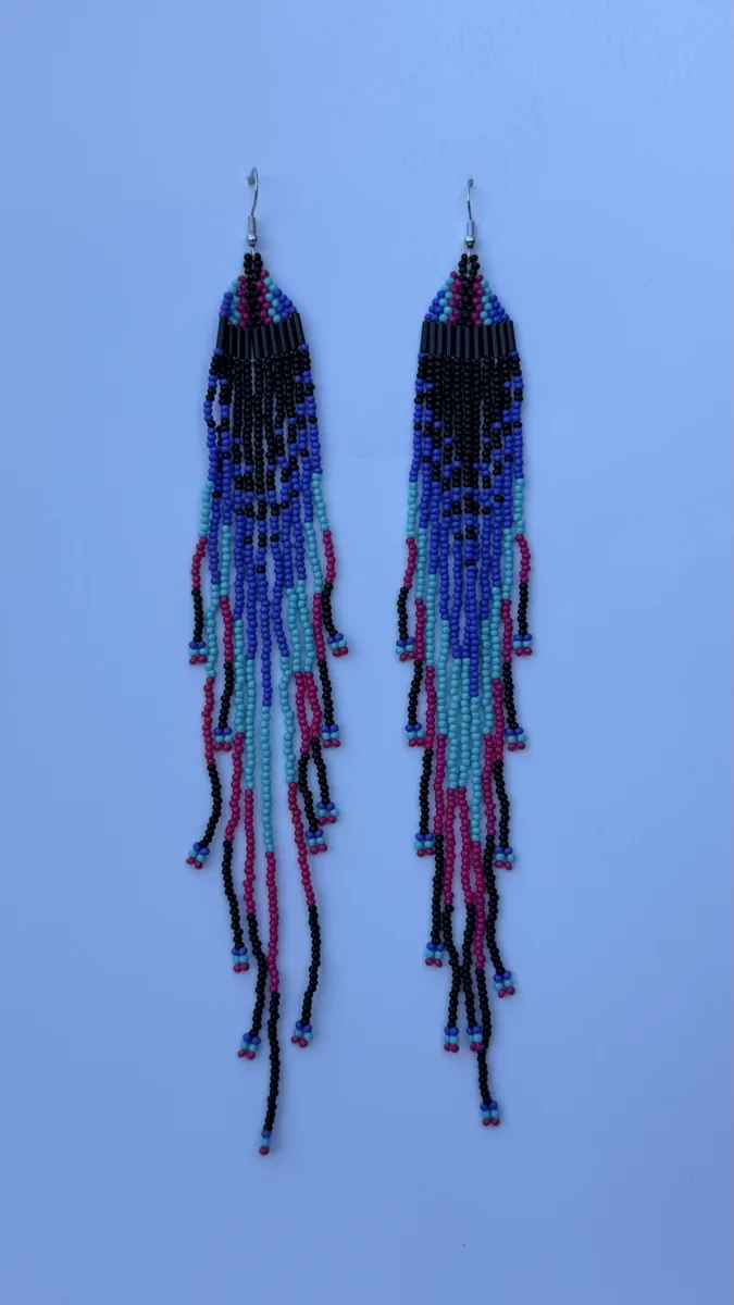 Pair of long beaded fringe earrings in black, blue, and pink.