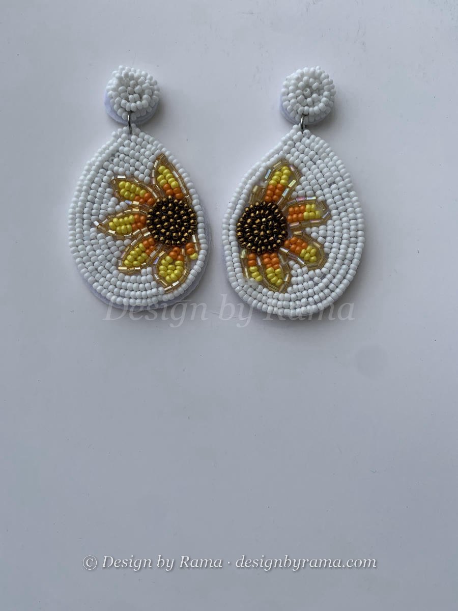 Beaded teardrop earrings with sunflower motif in warm white and yellow seed beads, round disc stud top.