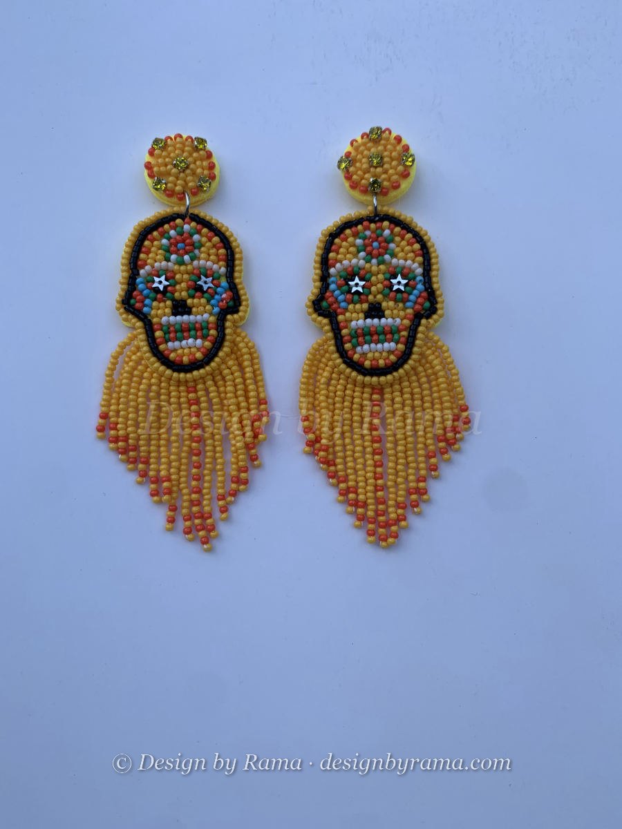 Beaded sugar skull earrings with colourful face and long yellow and orange seed bead fringe tassel.