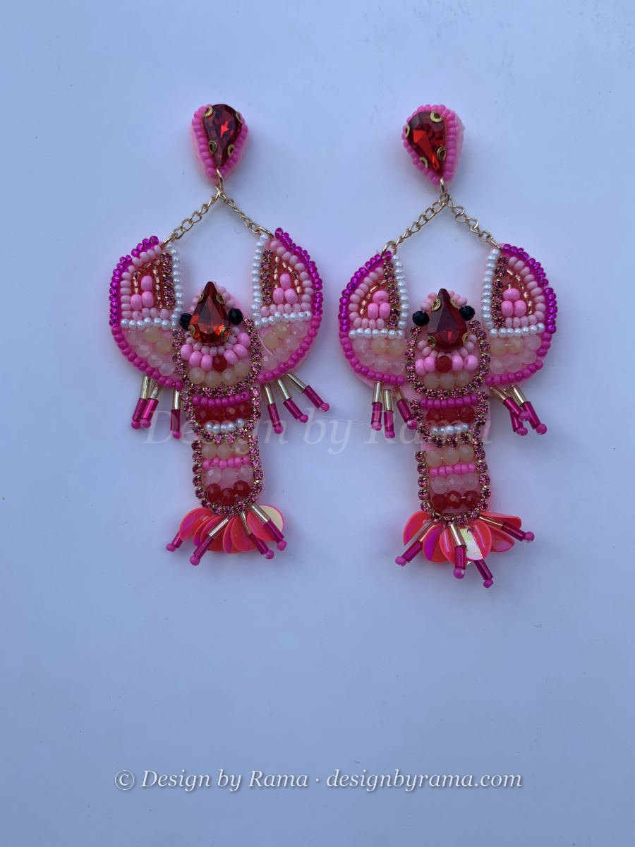 Beaded lobster earrings in fuchsia and pink with crystal body accents, sequin fan tail, and teardrop crystal stud on gold chain.