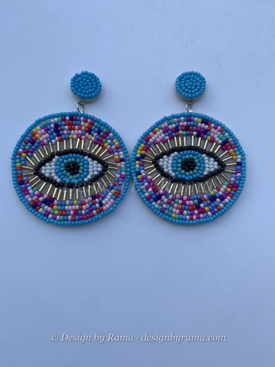 Large round disc earrings with beaded evil eye motif, gold bugle bead lashes, multicolour seed bead surround, and turquoise stud top.