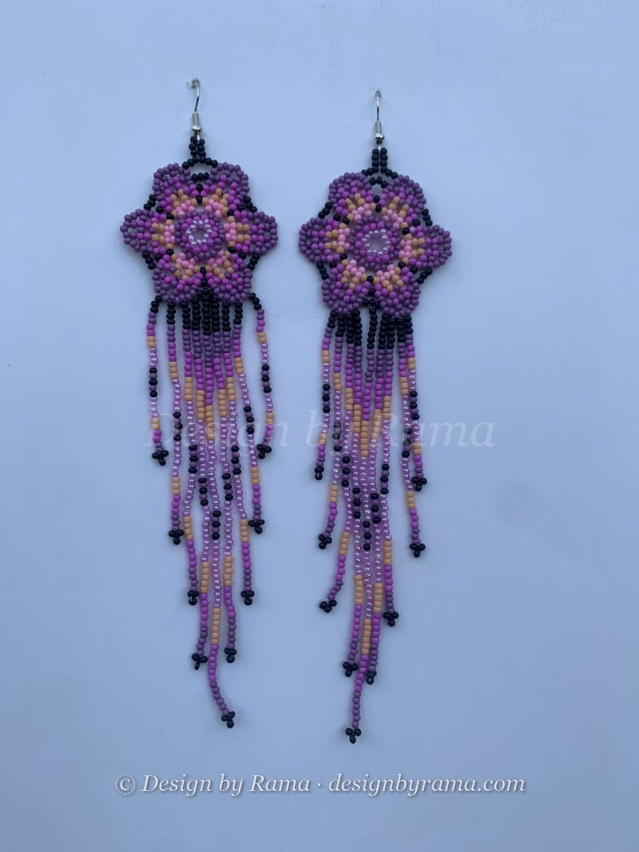 Long fringe earrings with purple and pink flower mandala on black ground, peach and mauve multi-strand fringe, wire hook.