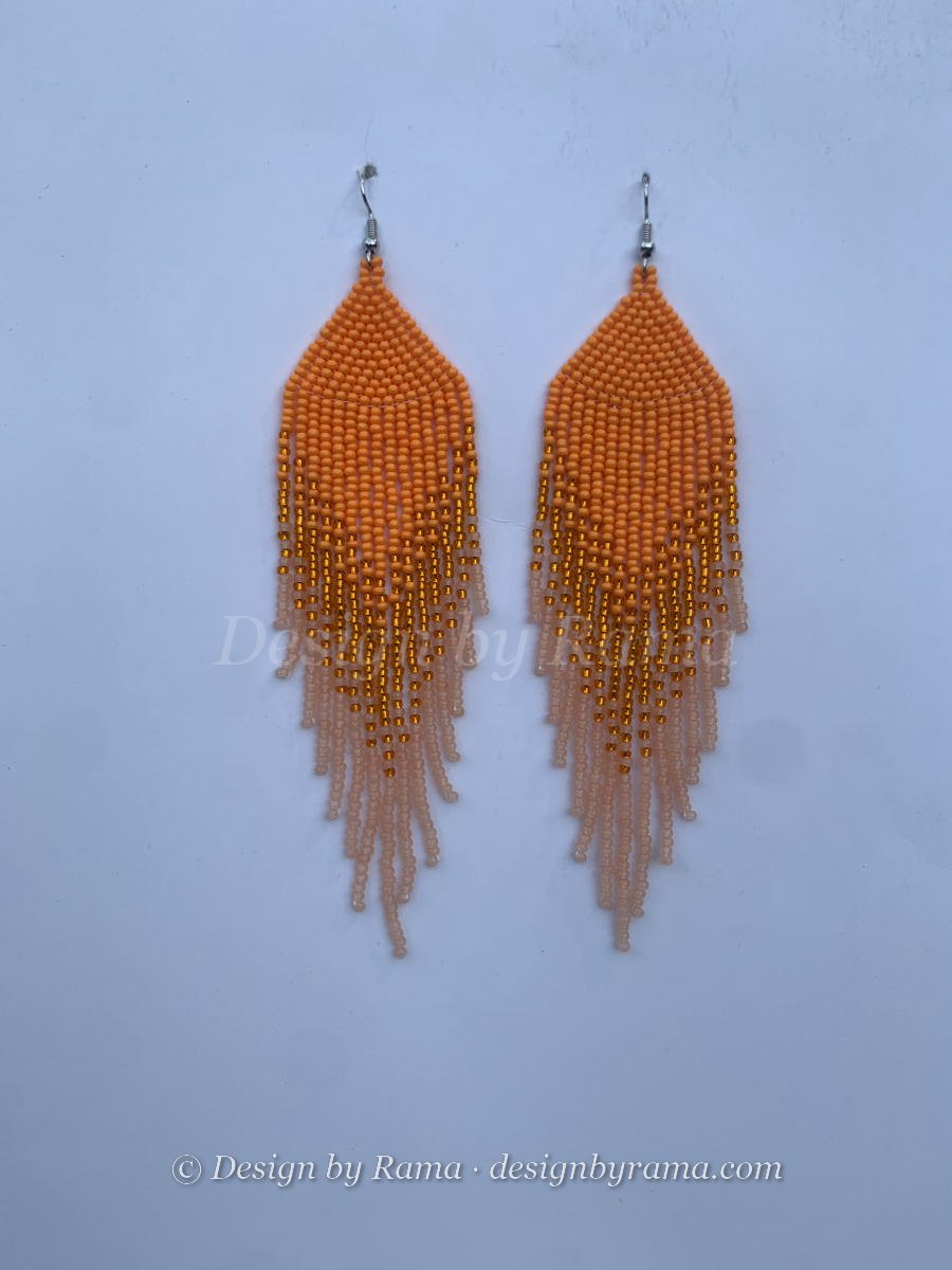 Long fringe earrings in orange seed beads fading to pale peach with gold metallic accent beads woven throughout, wire hook.