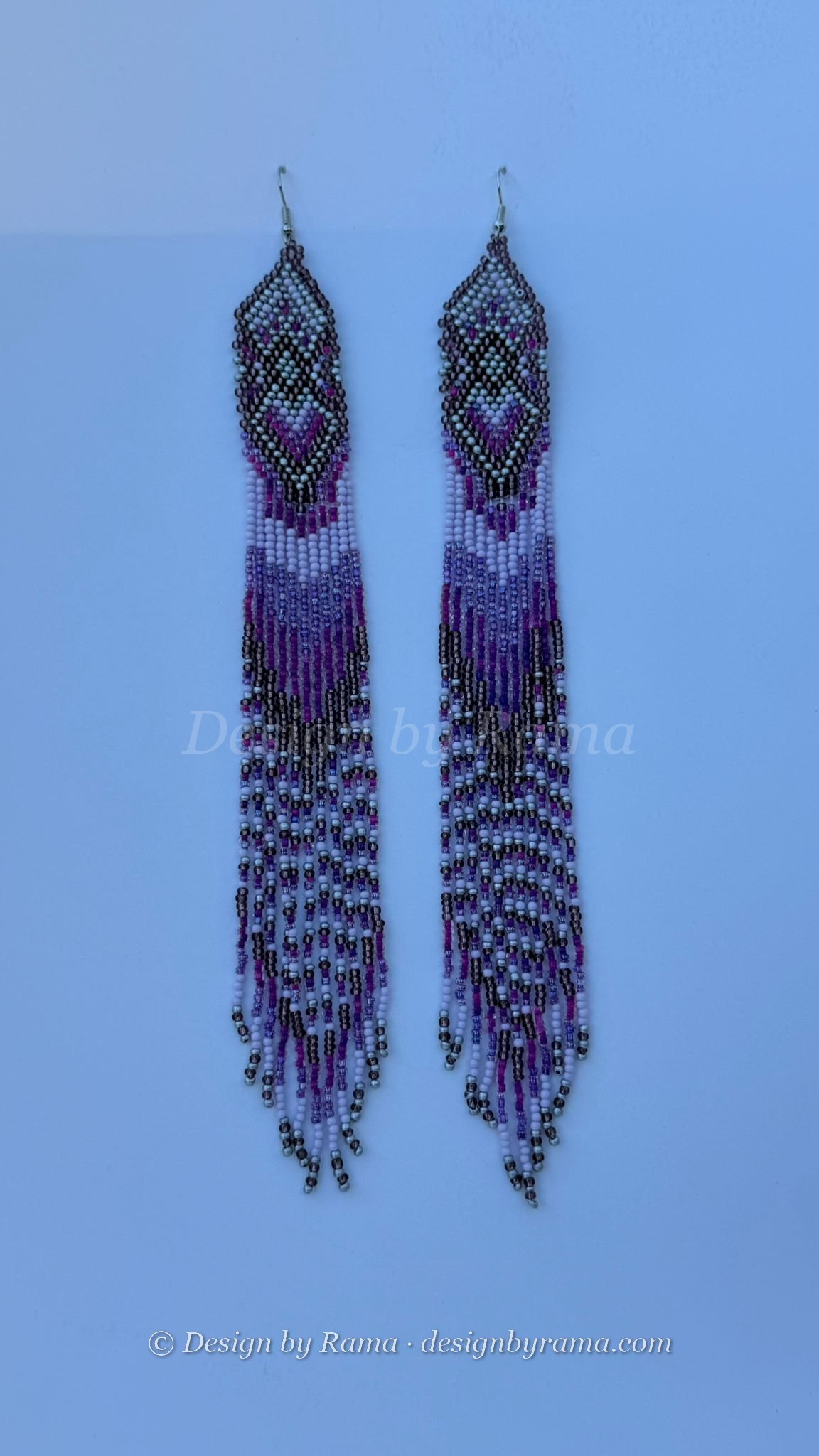 Pair of long beaded earrings in purple, black, and silver with geometric tops and fringe strands.