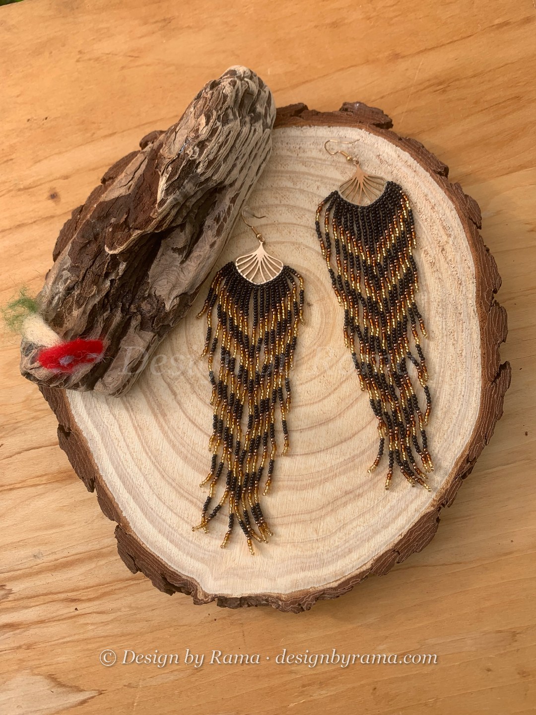 Pair of black and bronze beaded fringe earrings with gold fan tops.
